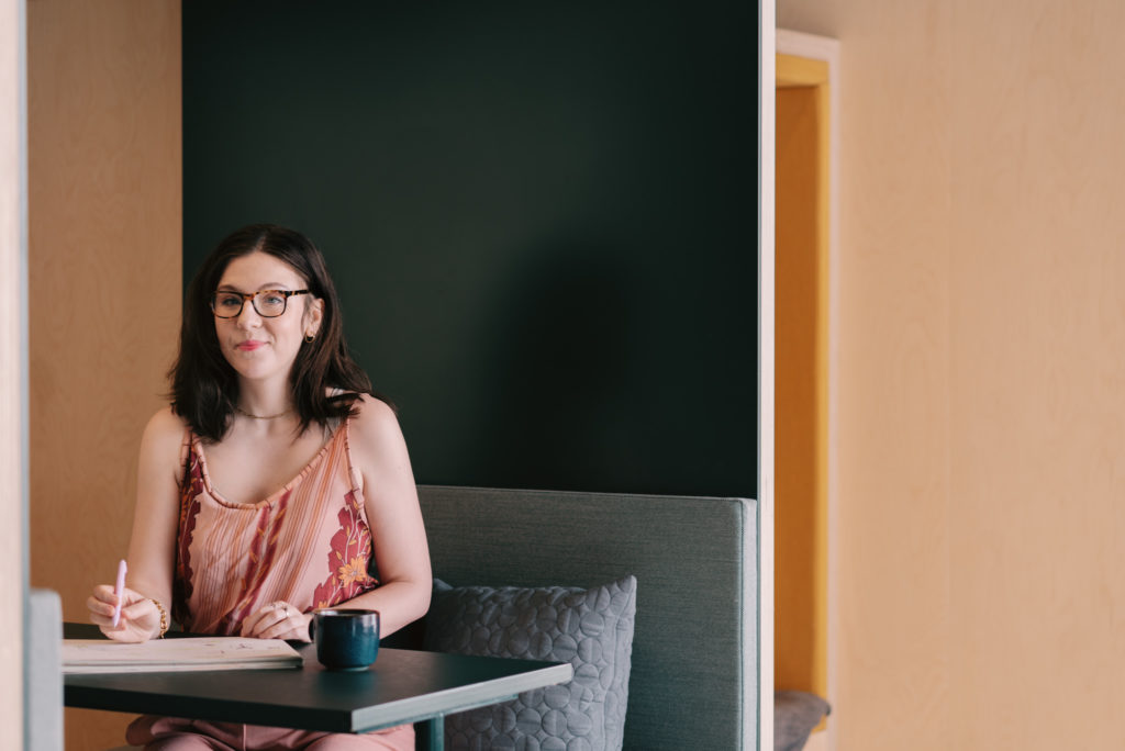 A portrait of Katie Barber taking some notes in a meeting